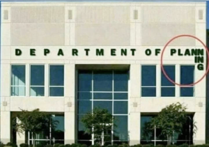building with sign: "Department of Planning", with "ing" going down the side of the building (didn't plan for the width of the building)